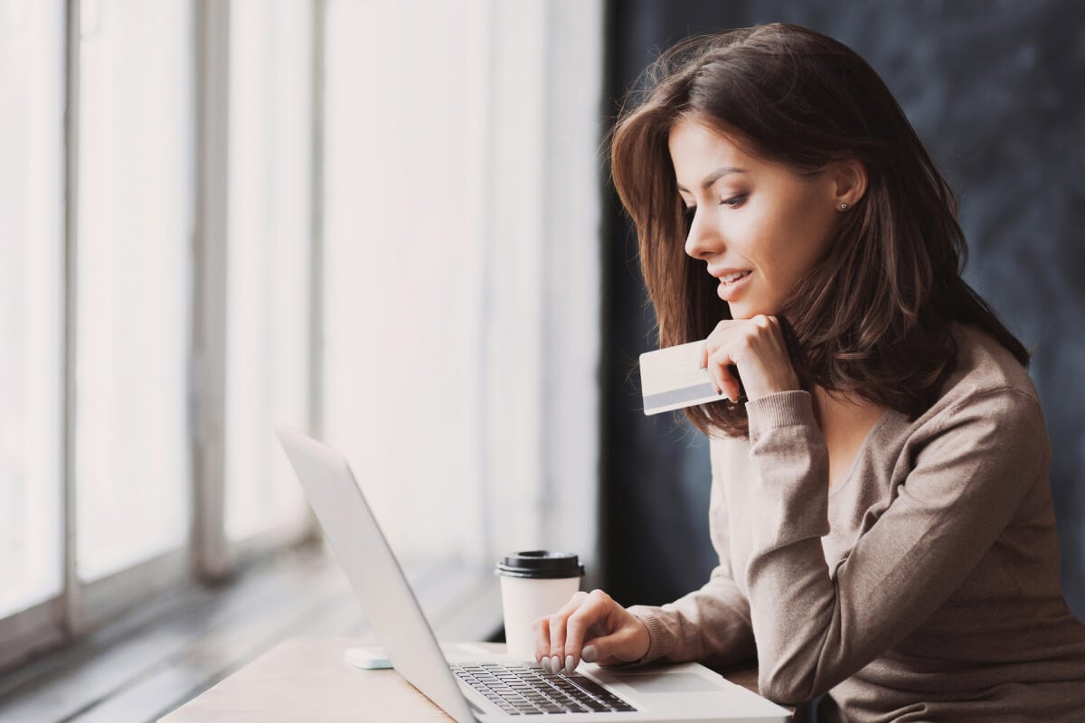 Someone at a computer or desk assessing card options.