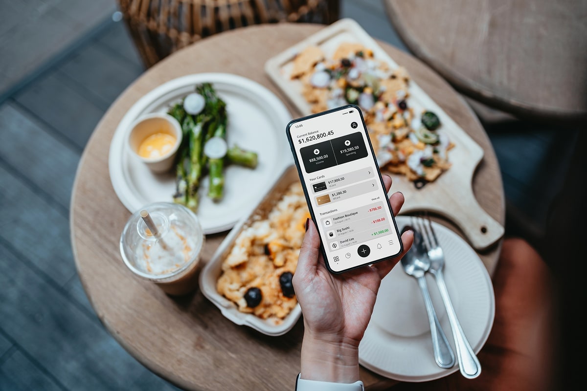 A professional image of a person reviewing their savings account balance on a smartphone.