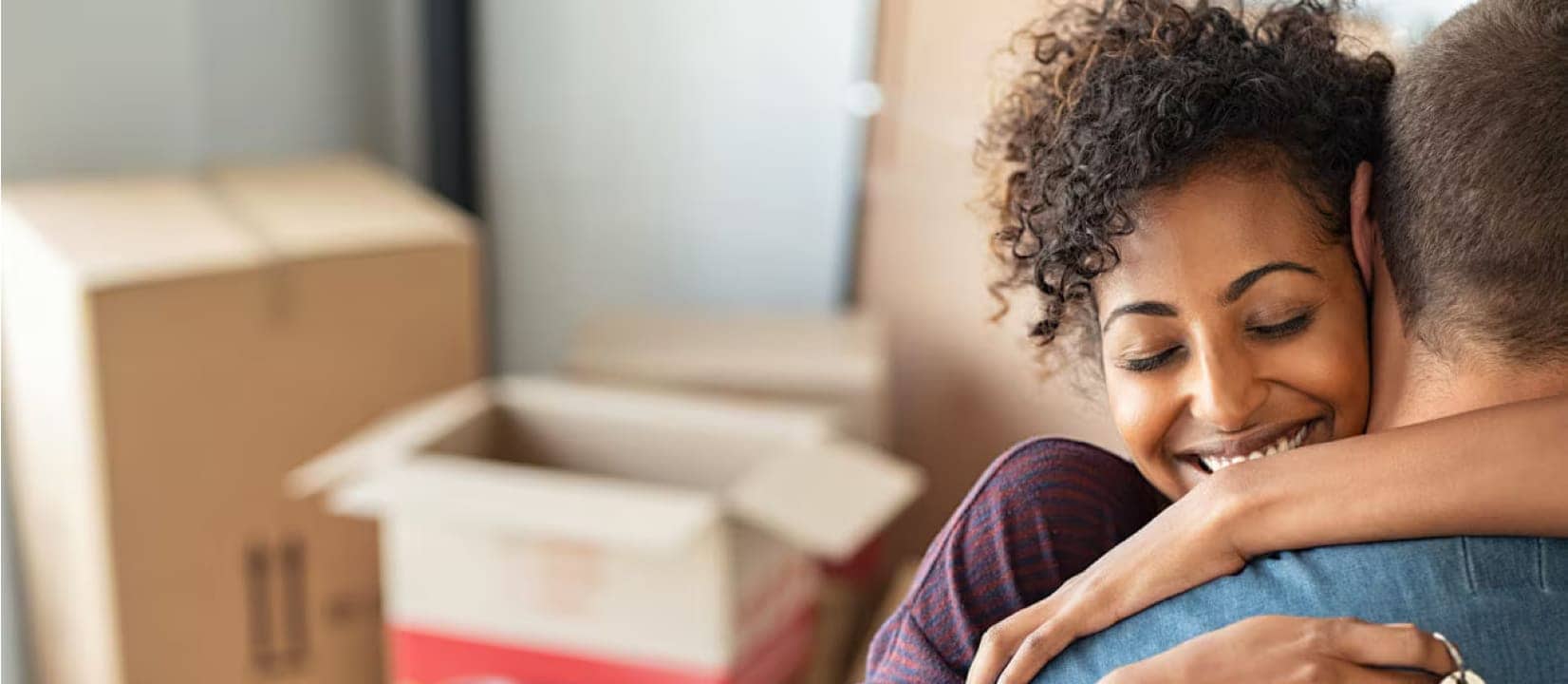 Woman and man are smiling and hugging