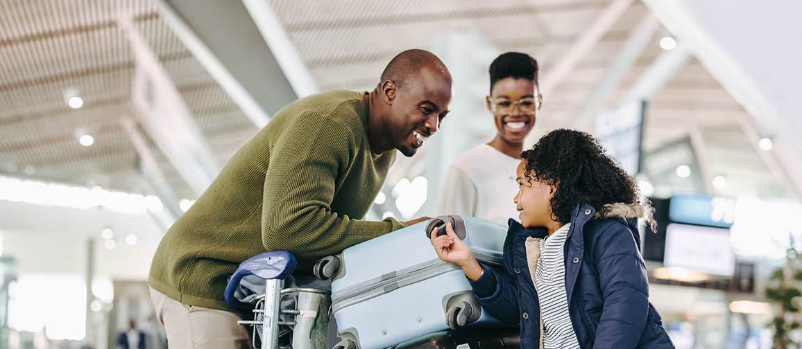 A family enjoying themselves in an airport while traveling.