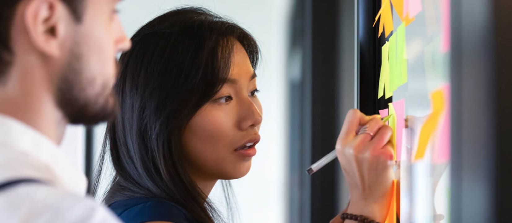 People are writing something on the posts on the wall