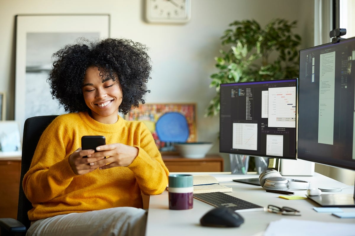 A professional image of a person using a mobile banking app to check their account balance.