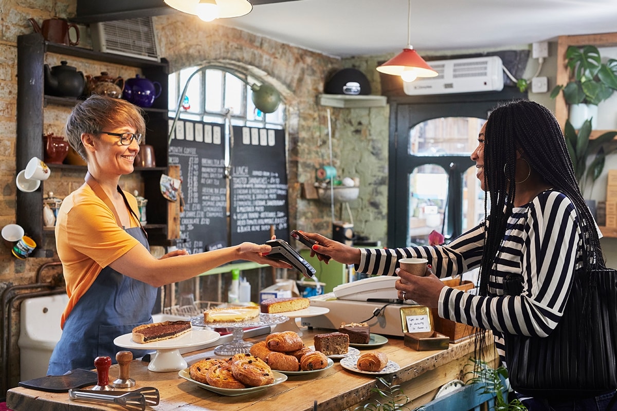 Someone working behind the counter at a coffee shop