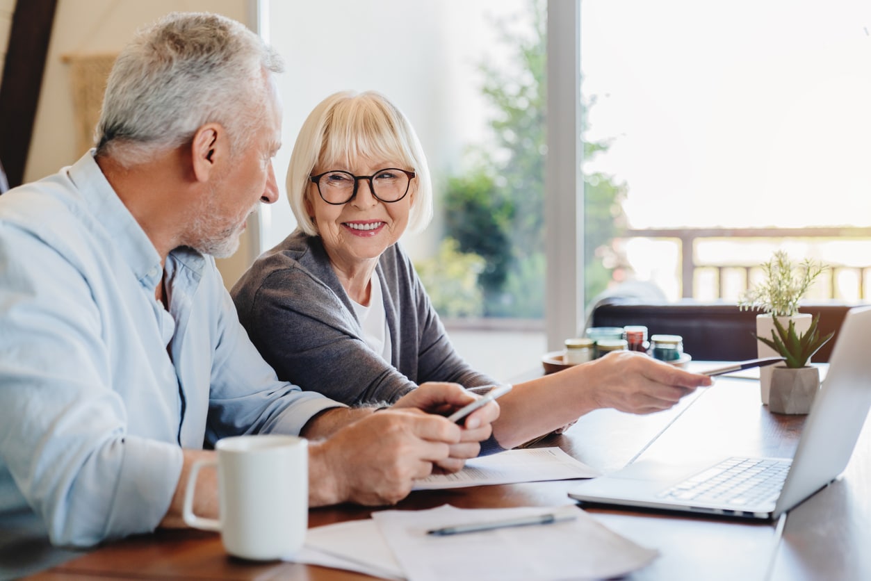 Two people discussing finances while sitting at a table