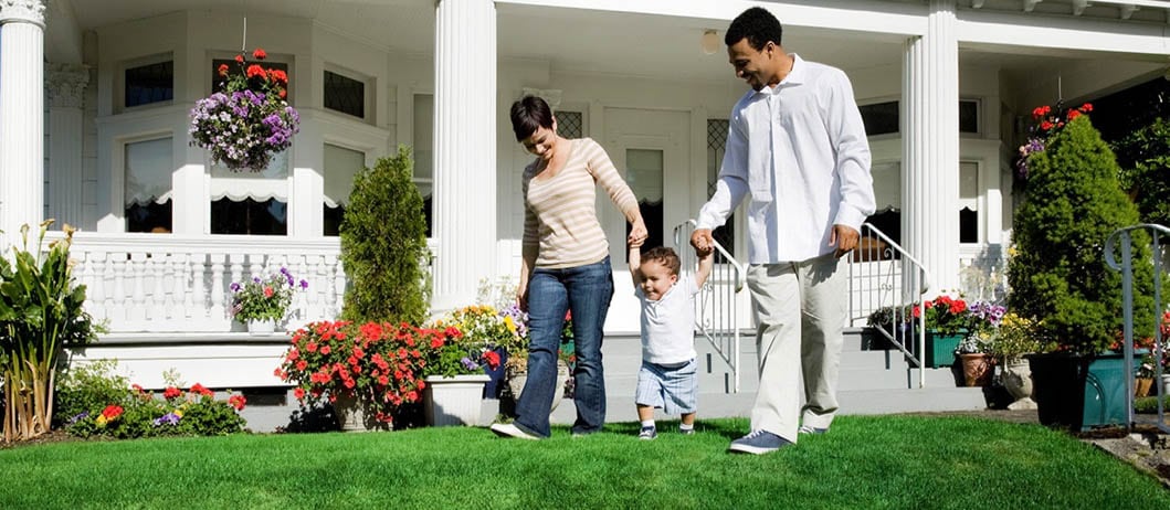 A family enjoying a pleasant day together on their front lawn.