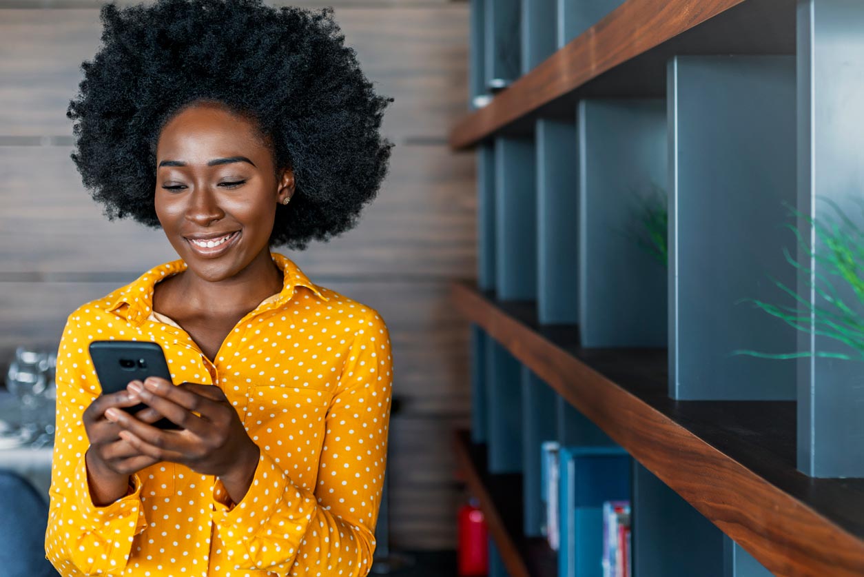 Woman is clicking her cellphone in her hands