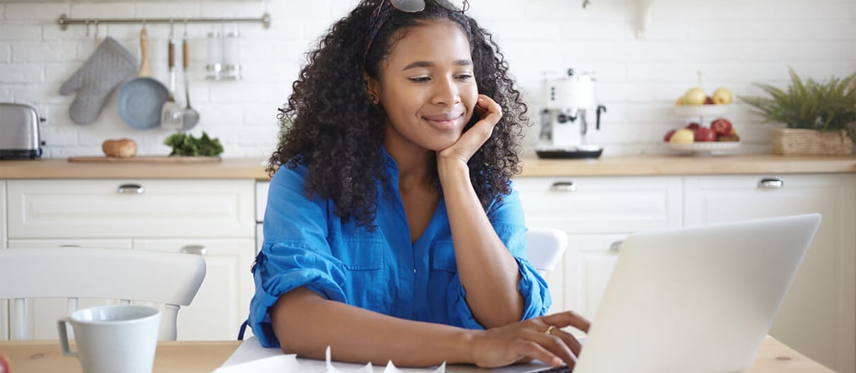 Woman using a laptop for paying bills online.