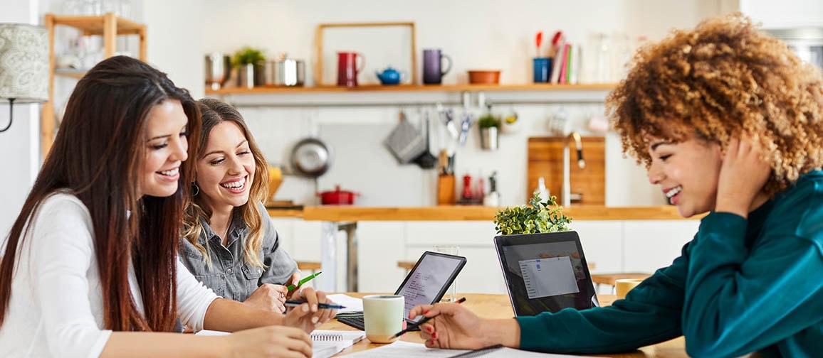 Three students studying together in a library