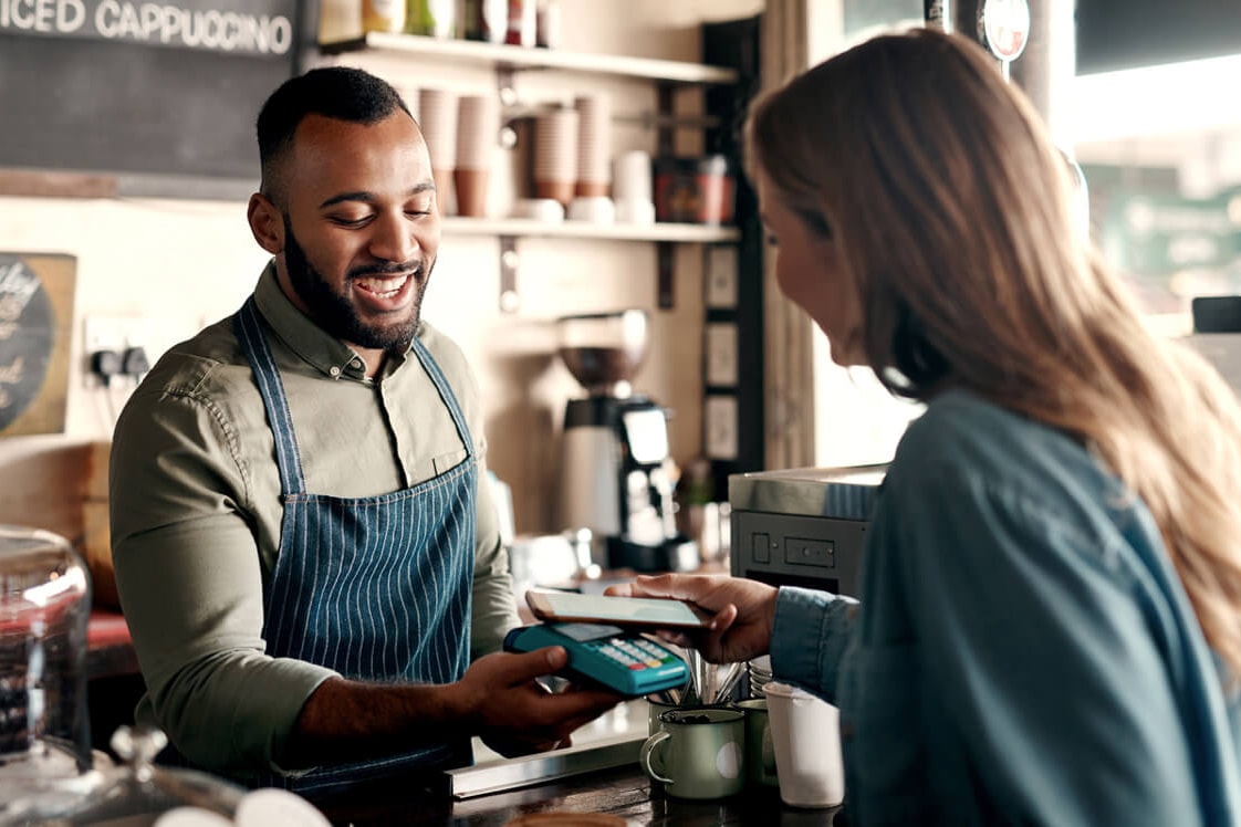 A person making a contactless payment with a smartphone