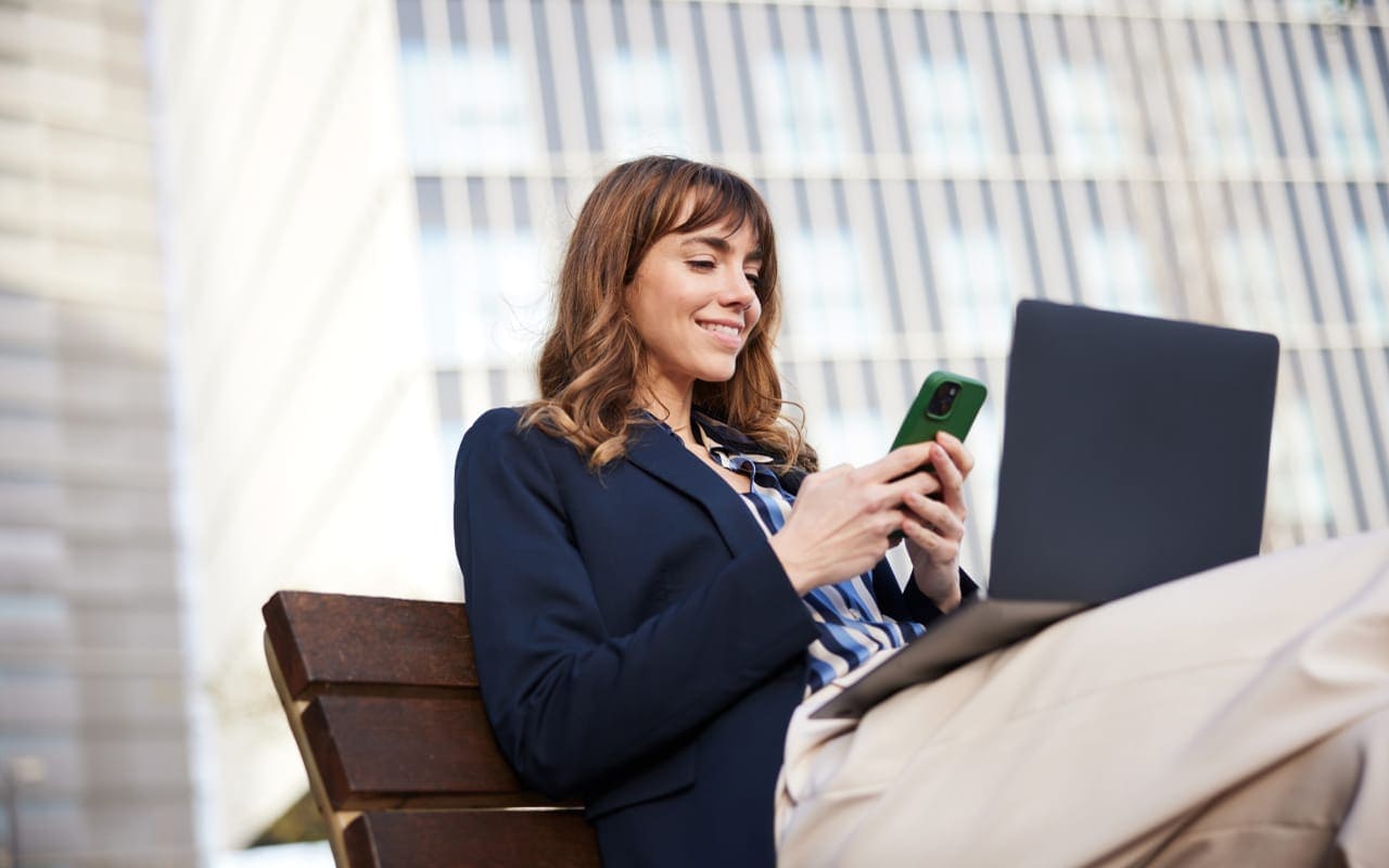 A professional image of a person checking their savings account balance on a smartphone, with a calm and focused expression, evoking financial awareness and planning.