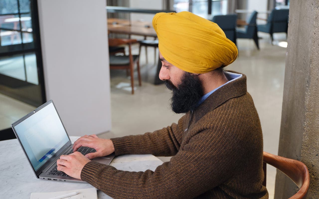 A professional image of a person reviewing financial options on a laptop, with a split screen showing a savings account balance and a retirement portfolio.
