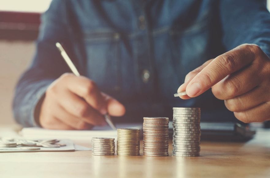 Person putting coins in stacks