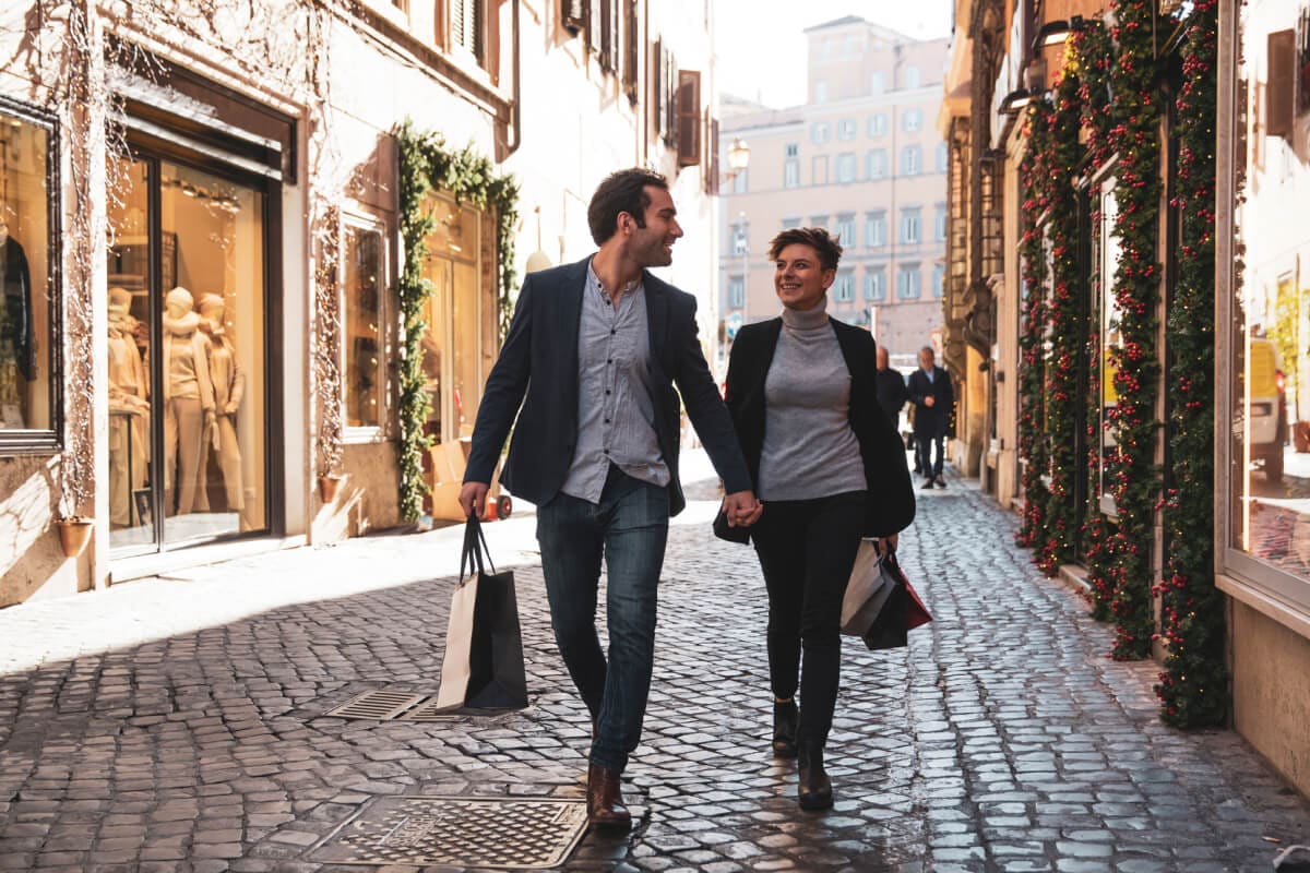Two people holding hands out for shopping.