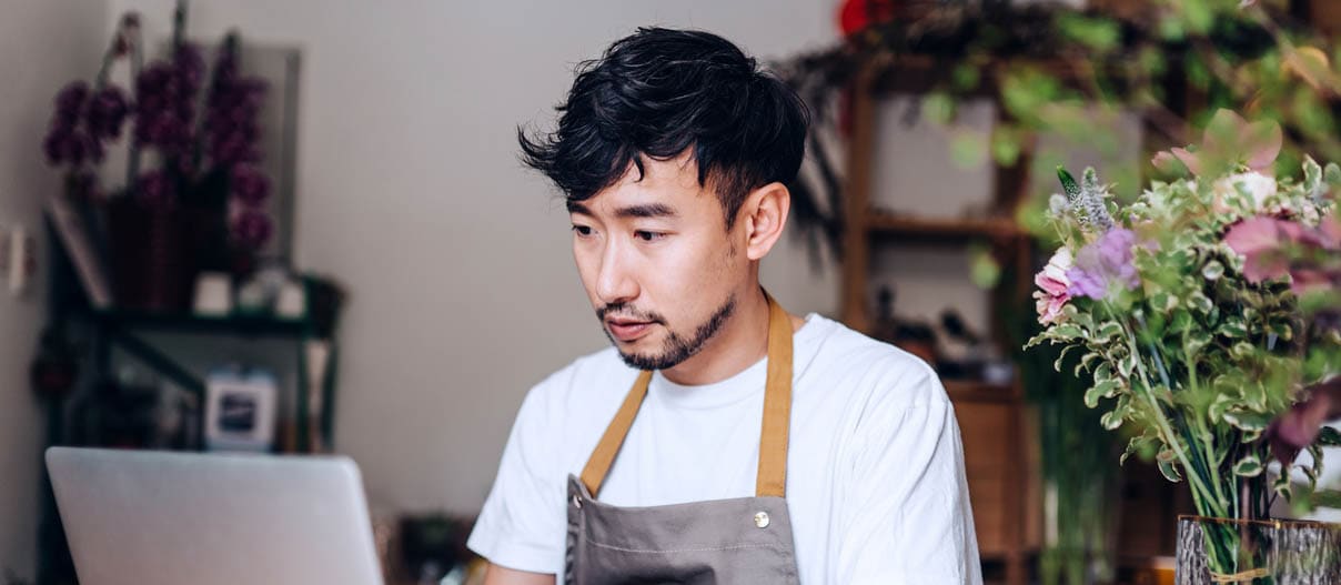 A man using laptop searching for what is line of credit and how it works.