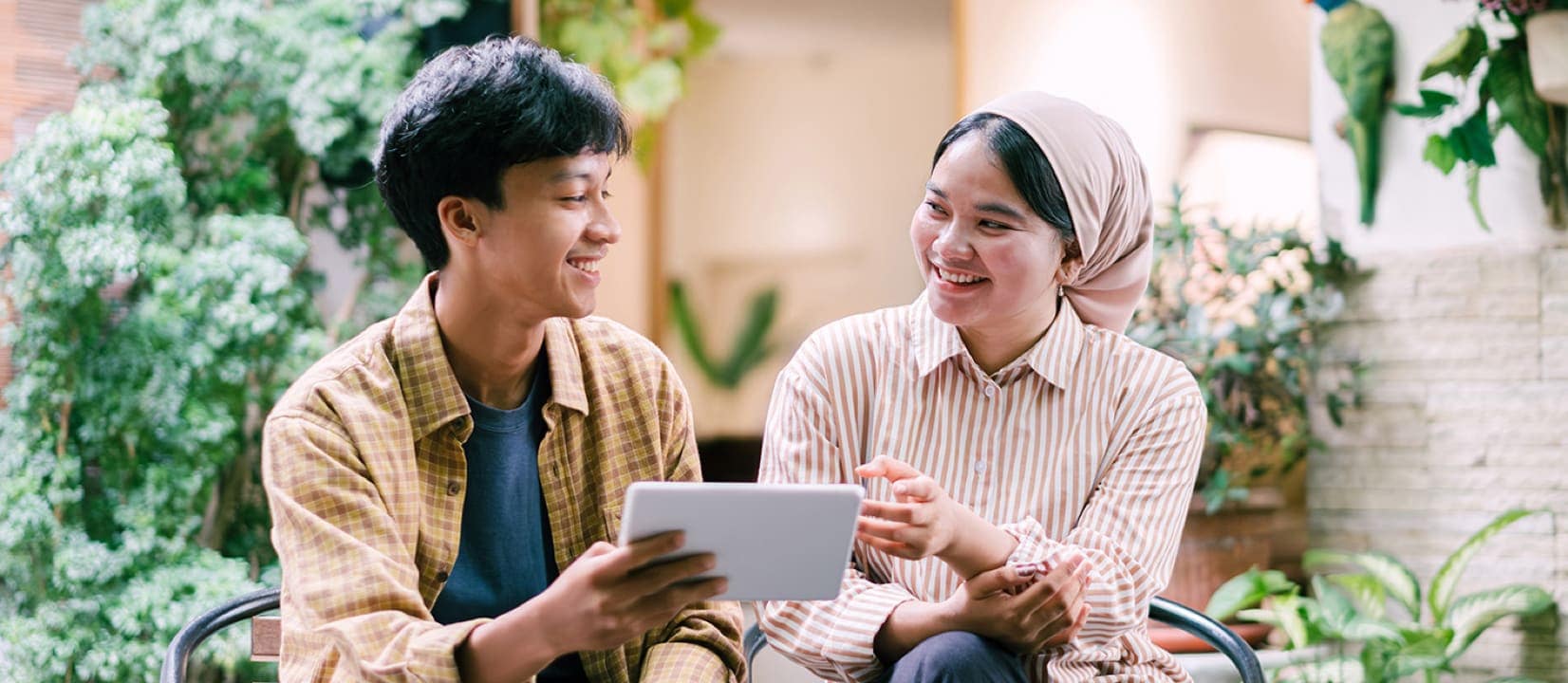 A couple looking at a tablet together.