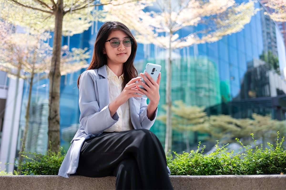 Someone checking a mobile banking app on their phone.