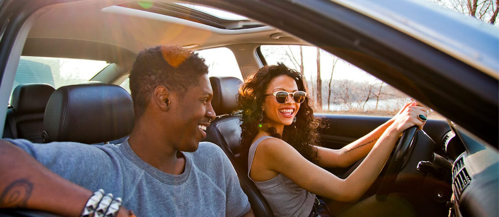 A couple discussing about how to prequalify for an auto loan in a car