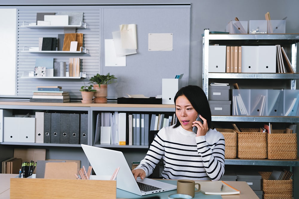A photo of a person analyzing investment risk tolerance on a laptop in a professional setting.