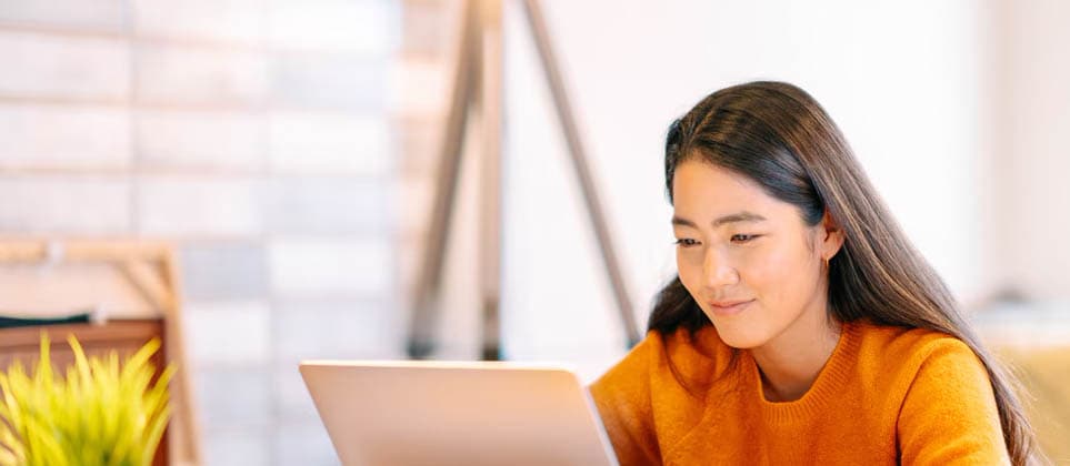 Woman searching for best travel booking tips on her laptop