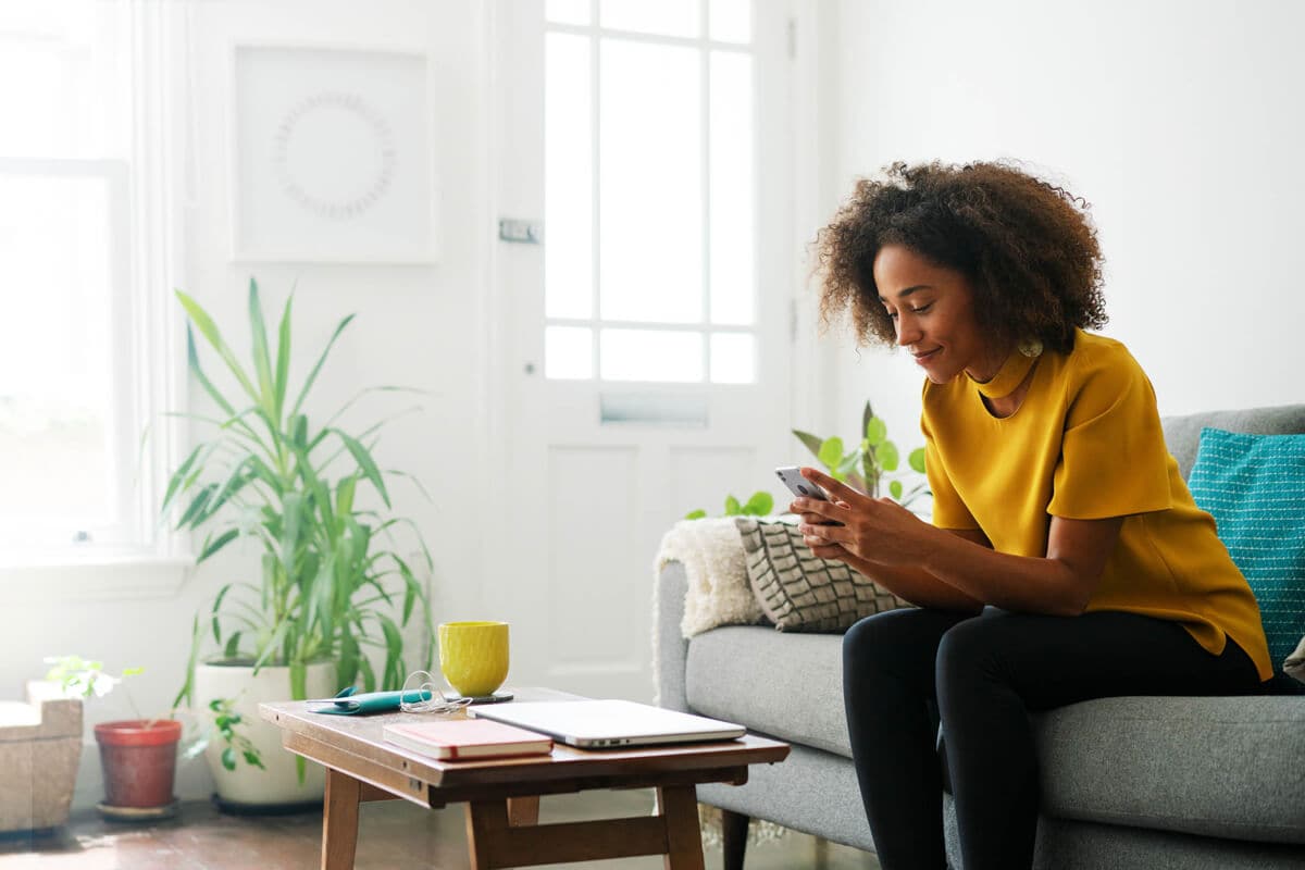 A person using a budgeting app on their smartphone to track expenses