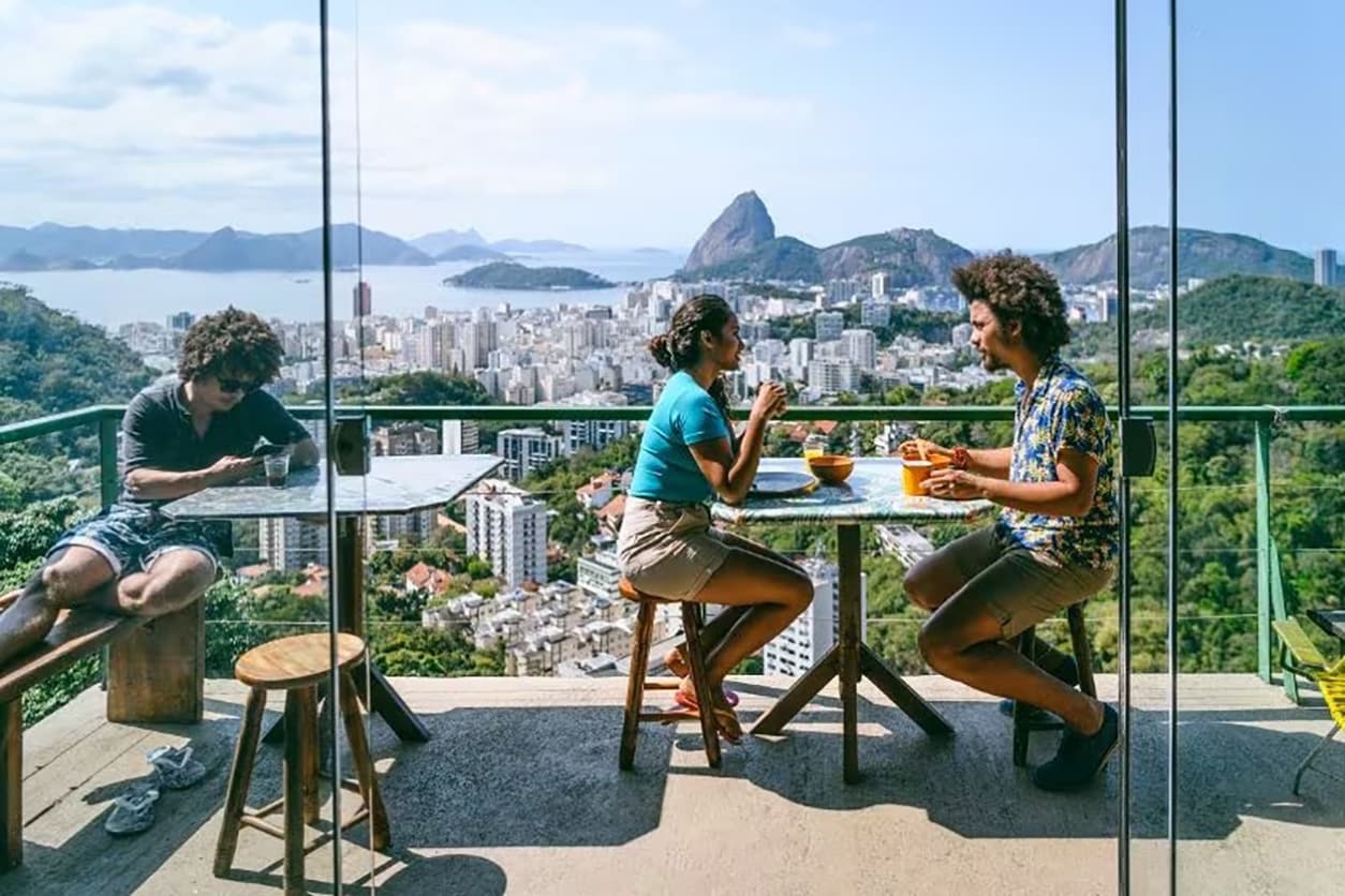 People eating outside on the deck of a restaurant