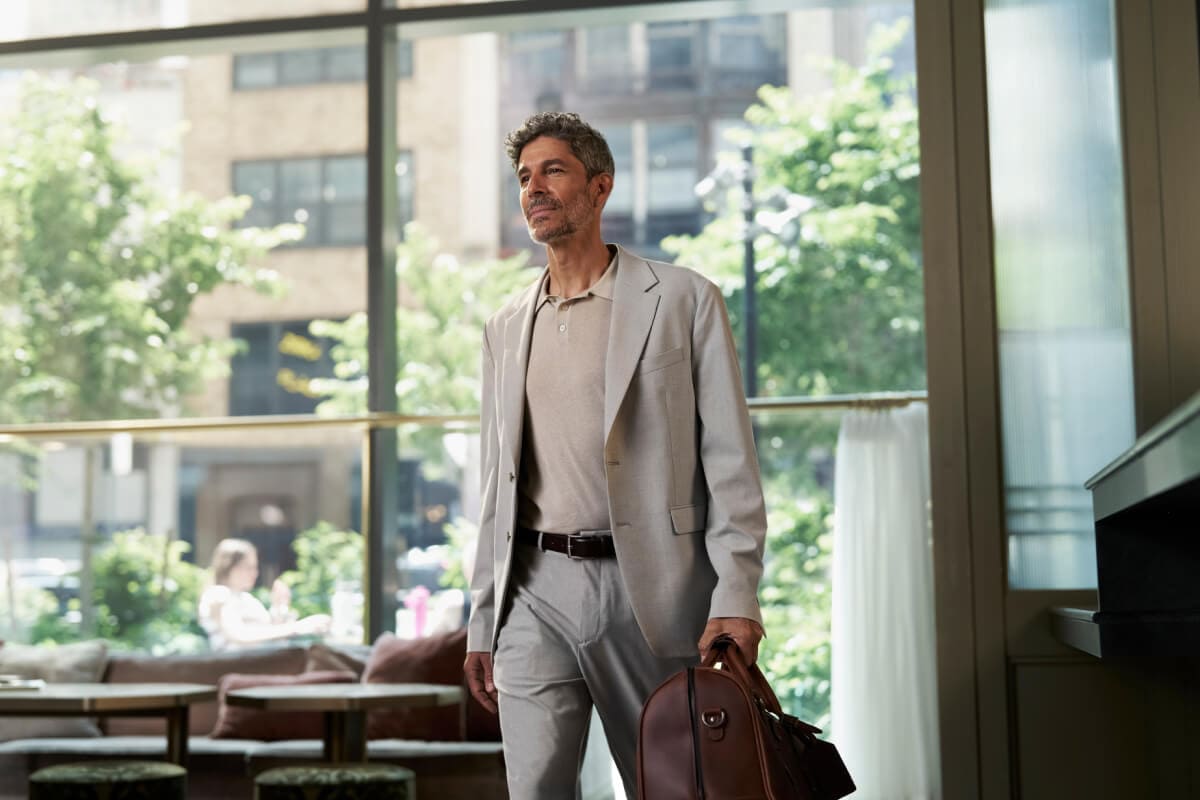 A person walking out of a bank with a brief case in hand.