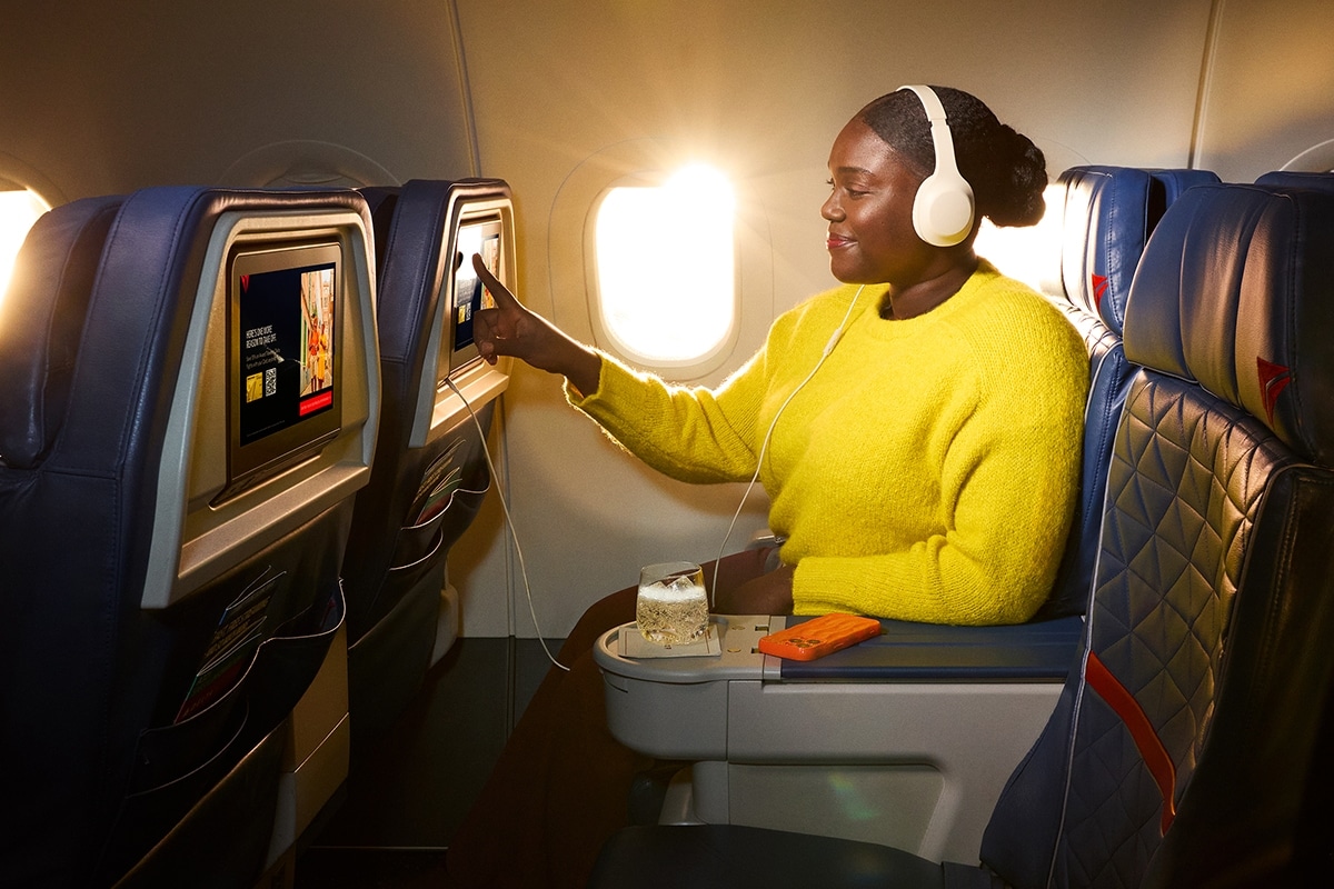 Someone on an airplane with an airline-provided drink or snack.