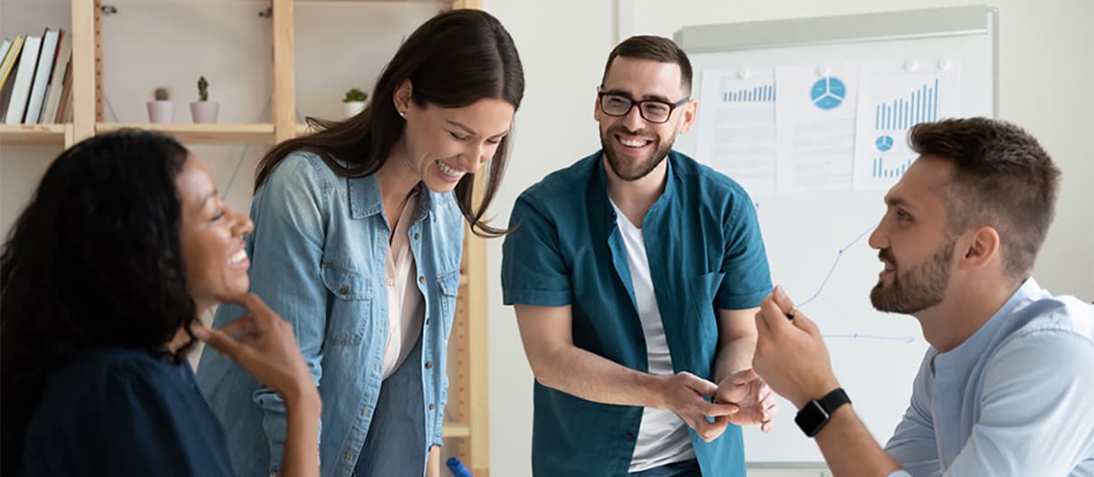 A group of people in an office having a discussion.
