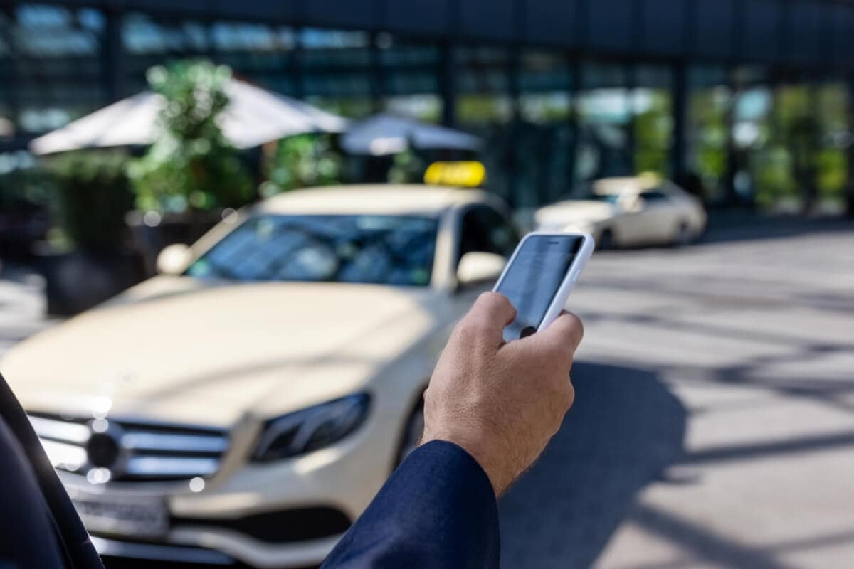 A person going through his phone on the street.