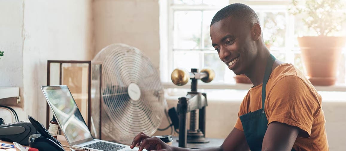 A person using a laptop, possibly accessing credit reference information.