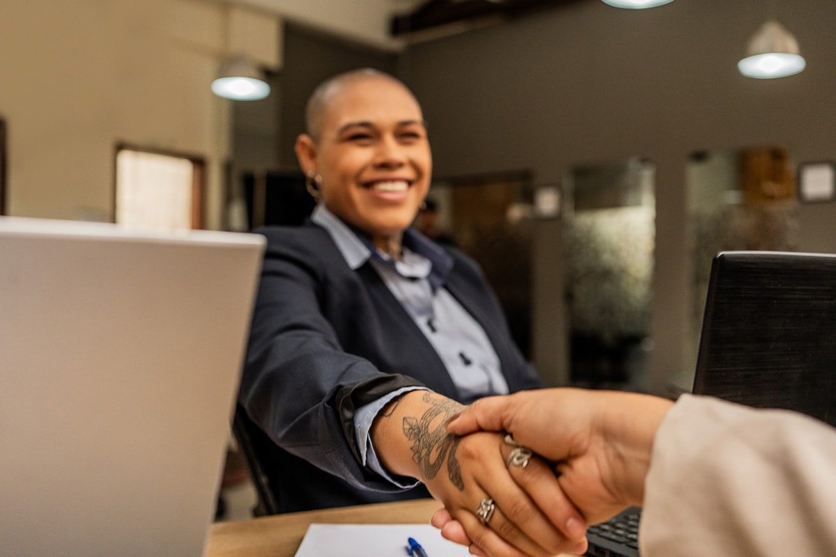 A person shaking hands with a colleague.