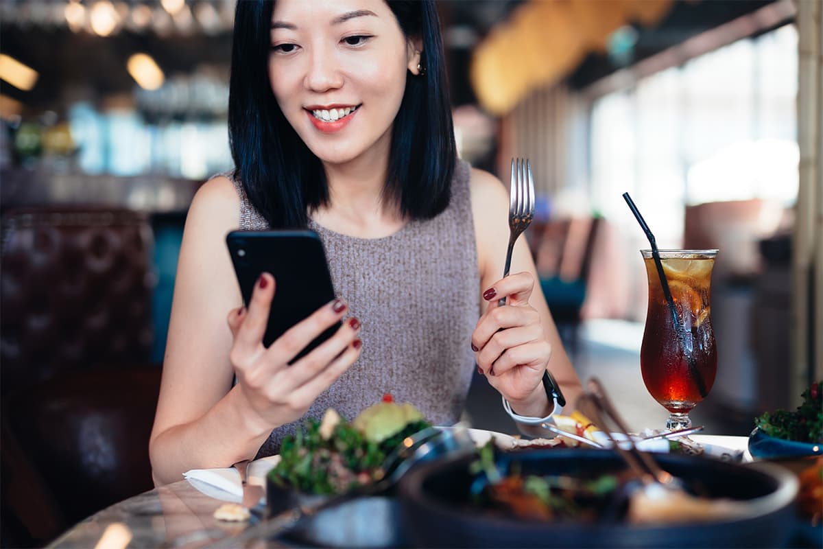 Someone checking their phone while in a store or restaurant setting
