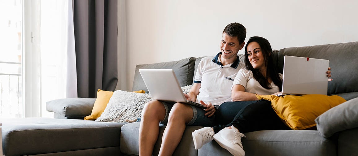 A couple researching about loan amortization on their laptop