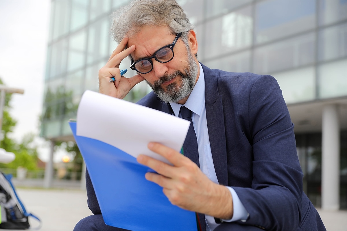 Someone reviewing a credit card statement and looking confused