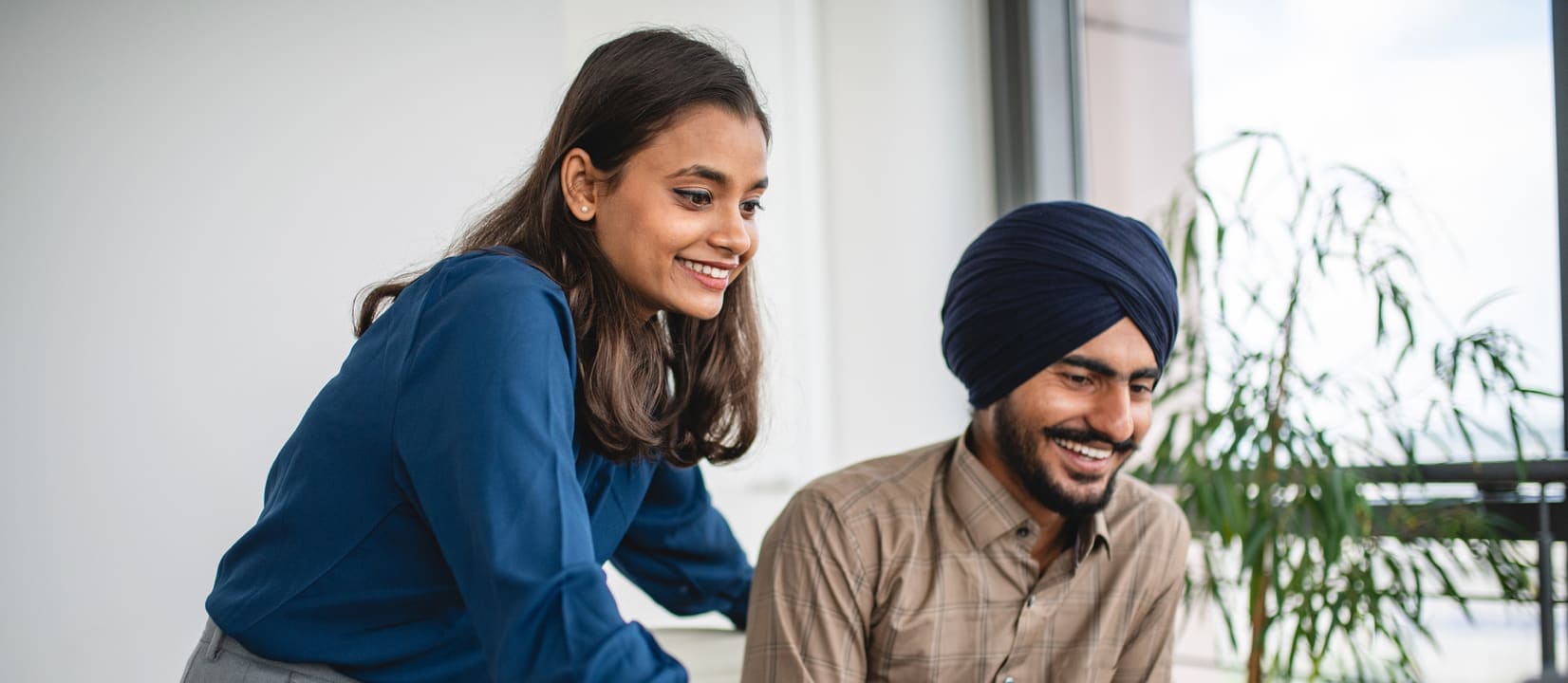 Two people are searching about what vesting is on a laptop.