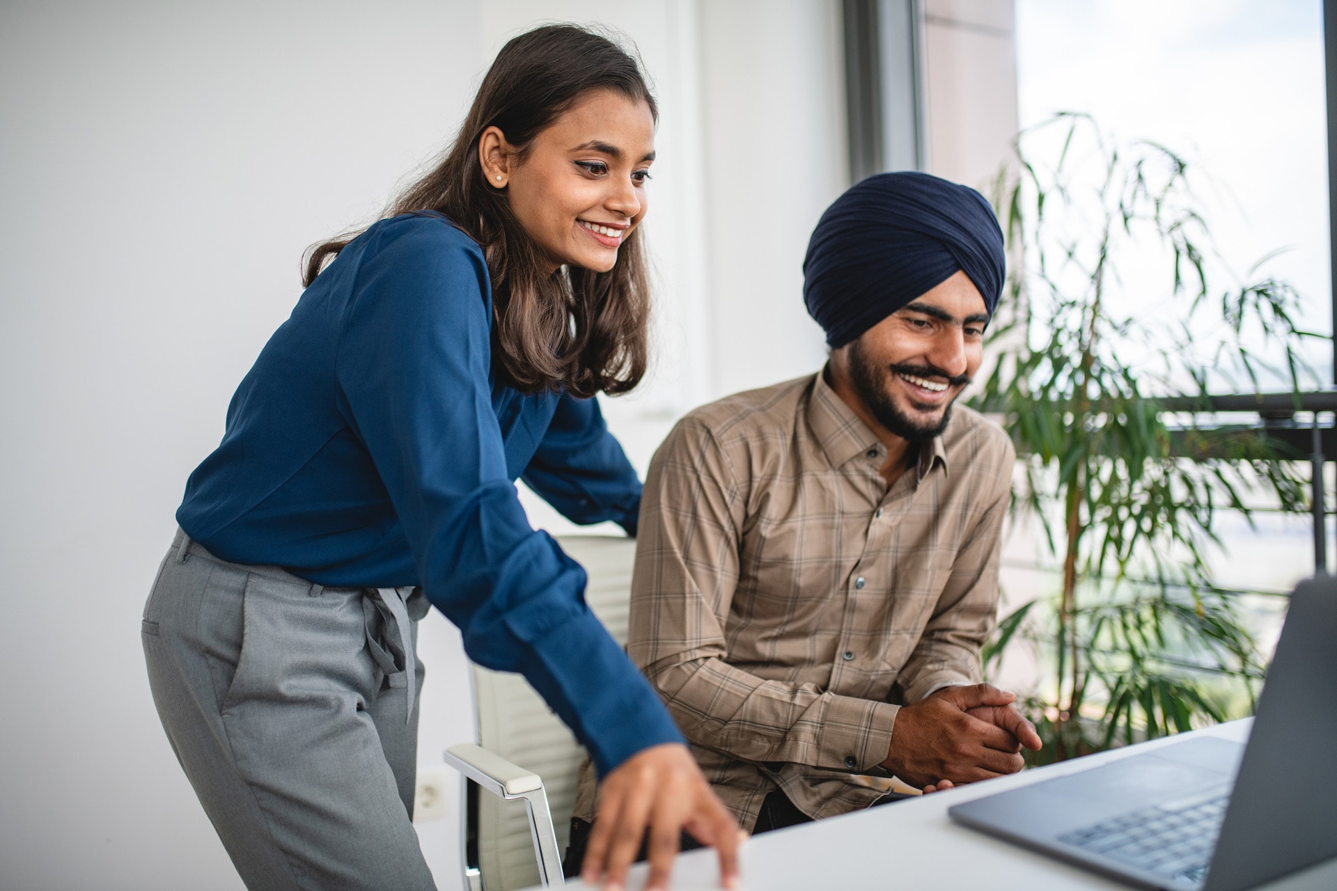 Two people are searching about what vesting is on a laptop.