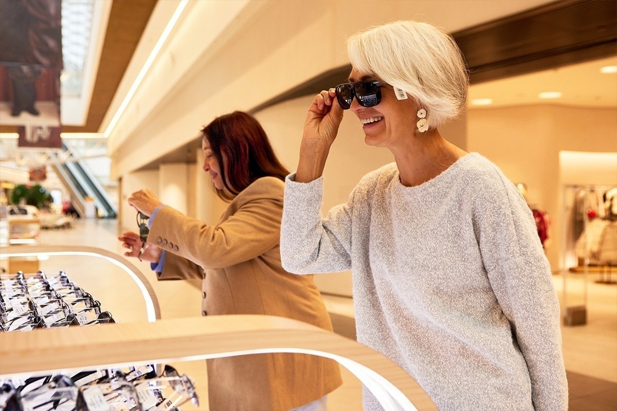 A lifestyle Saks image, someone entering Saks with the building facade displayed.