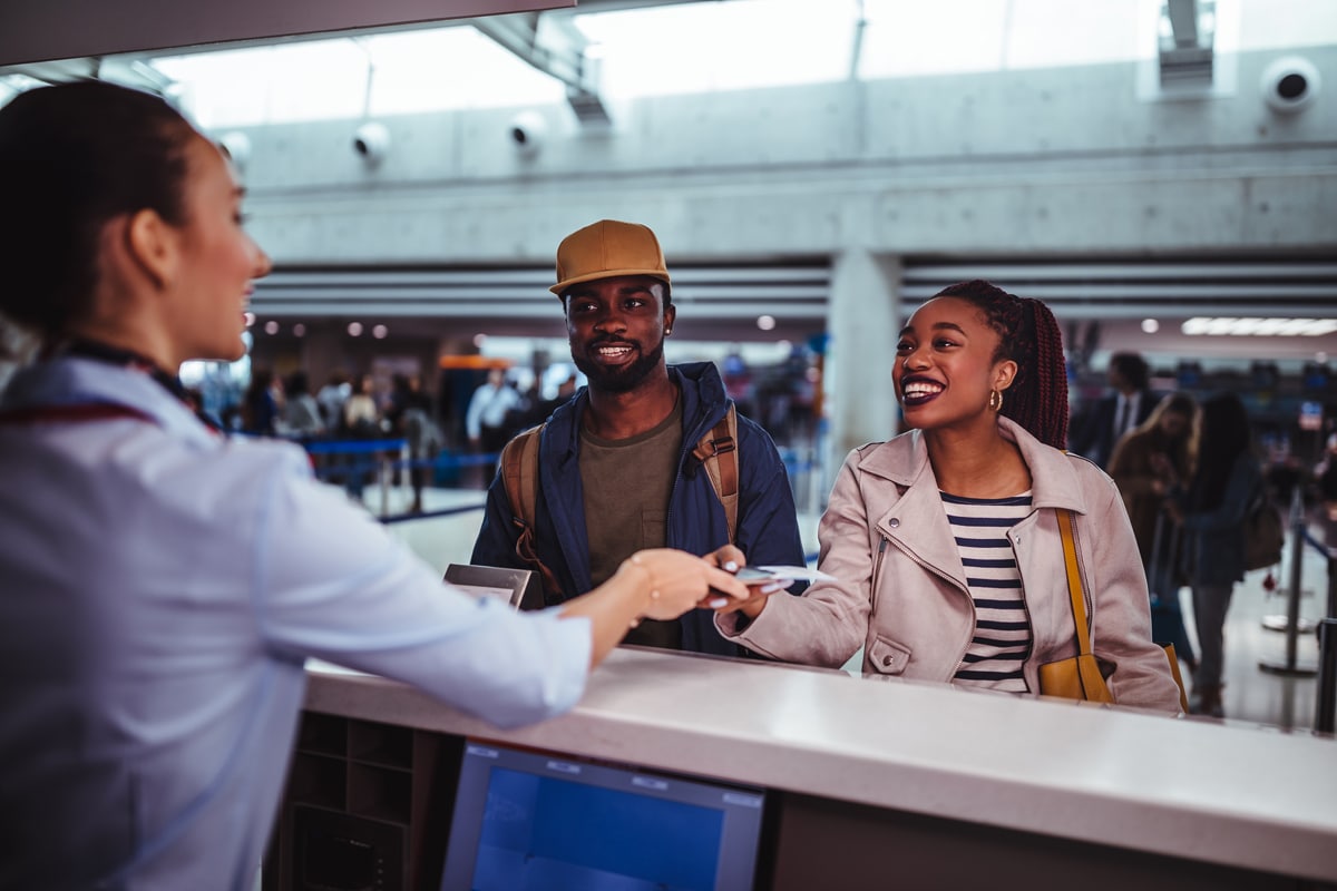 Father, mother and a child at the airport are waiting and smiling