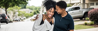 A couple walking down the street looking happy together