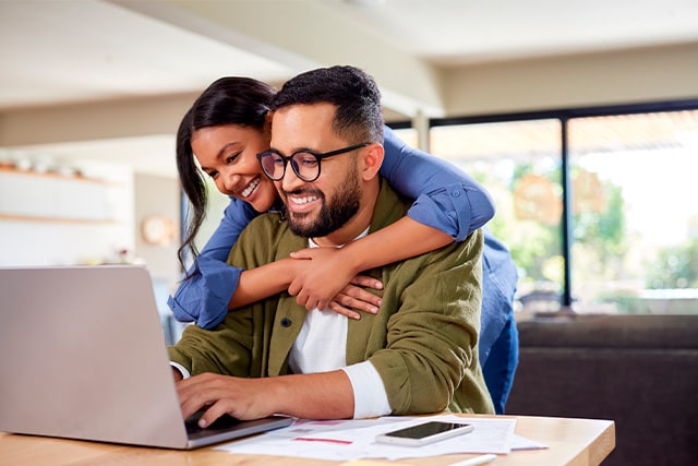 Una pareja en casa revisando sus finanzas.