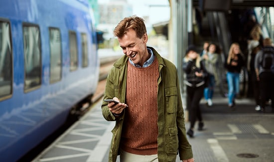 A couple sitting together and looking at a laptop
