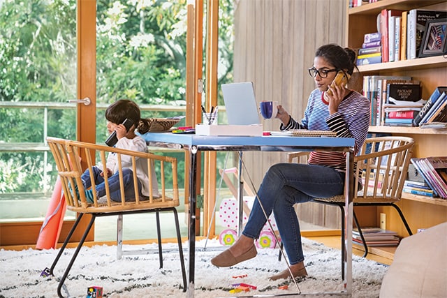 Two women chat in a furniture store.