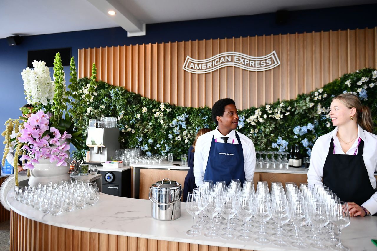 American Express private lounge , the bar and staff behind it