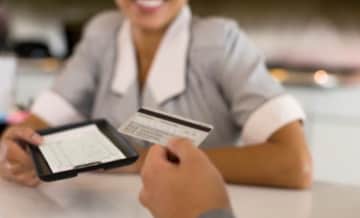 Business Woman using card at till
