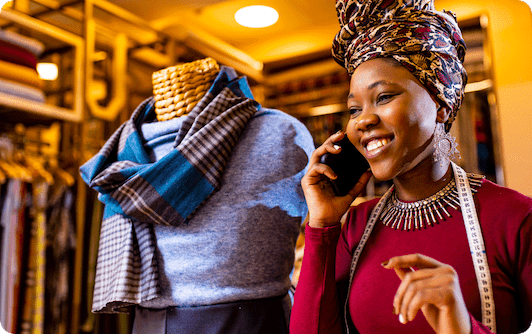 A business owner speaking on the phone at her local boutique.