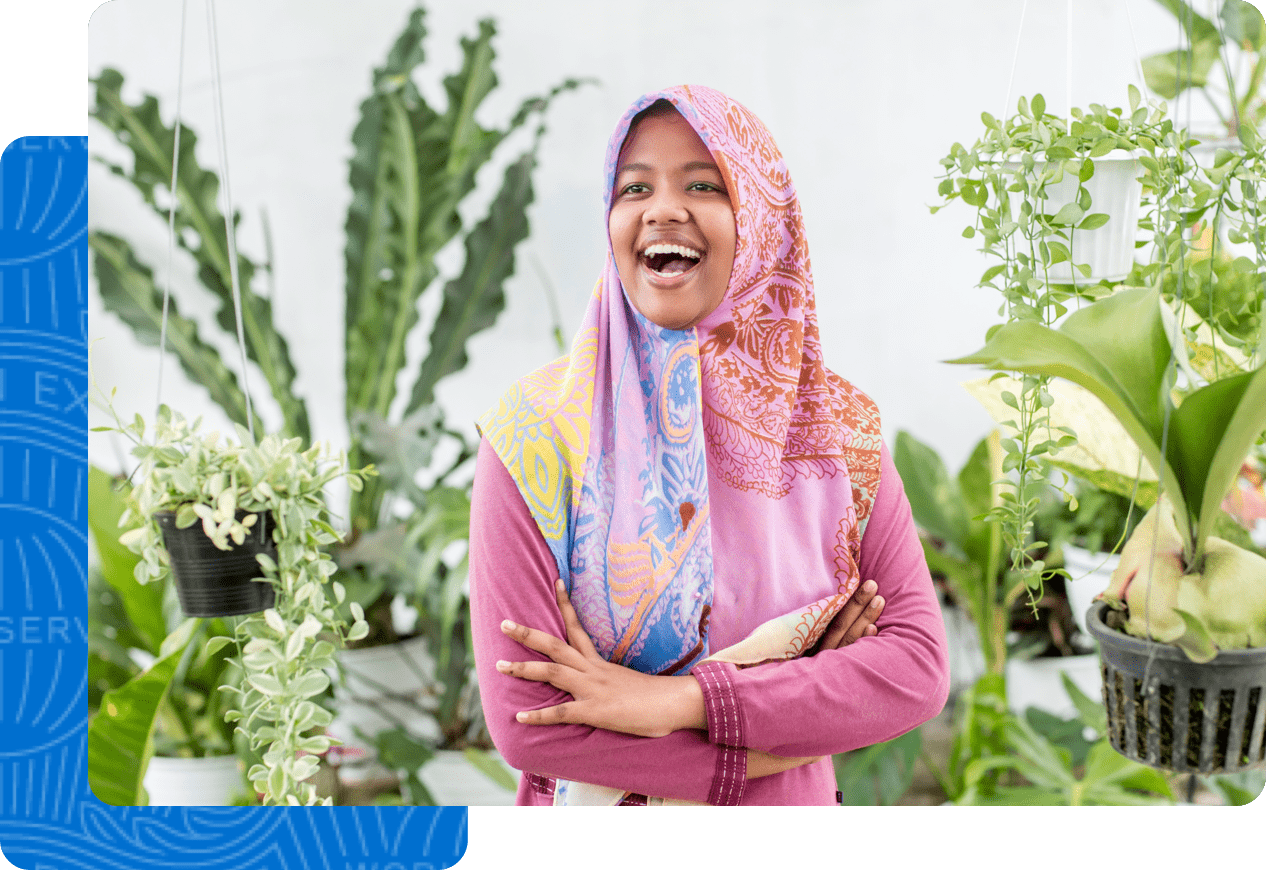 Female business owner smiling in front of her store 