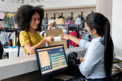Woman at retail store checking out order at counter