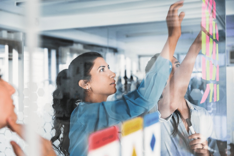 Person brainstorming with post-it notes