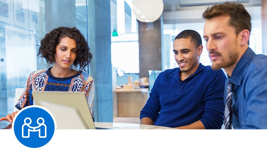 A partnership icon over scenes of employees discussing a business purchase. 
