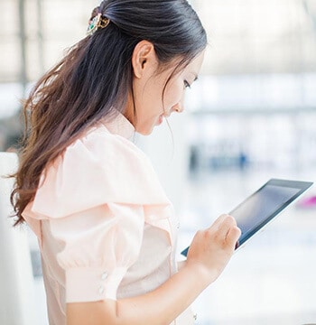 woman looking at tablet